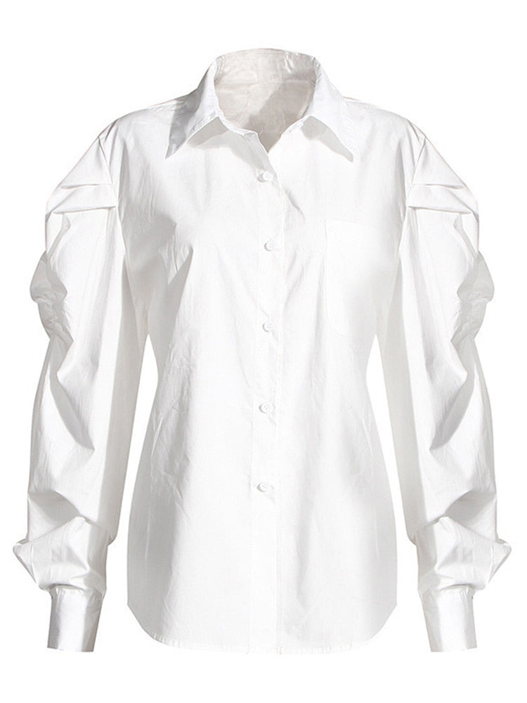 Distinctive two-piece set, a blue denim blouse with an unusual cut, a white loose-fitting long-sleeved shirt and a buttoned-collar