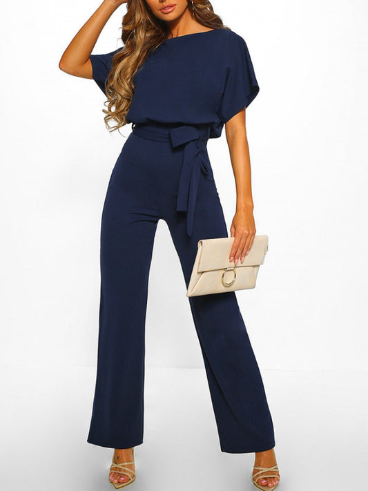 An elegant one-piece jumpsuit with a high waist and short flared sleeves, featured in several colors, with a tie at the waist