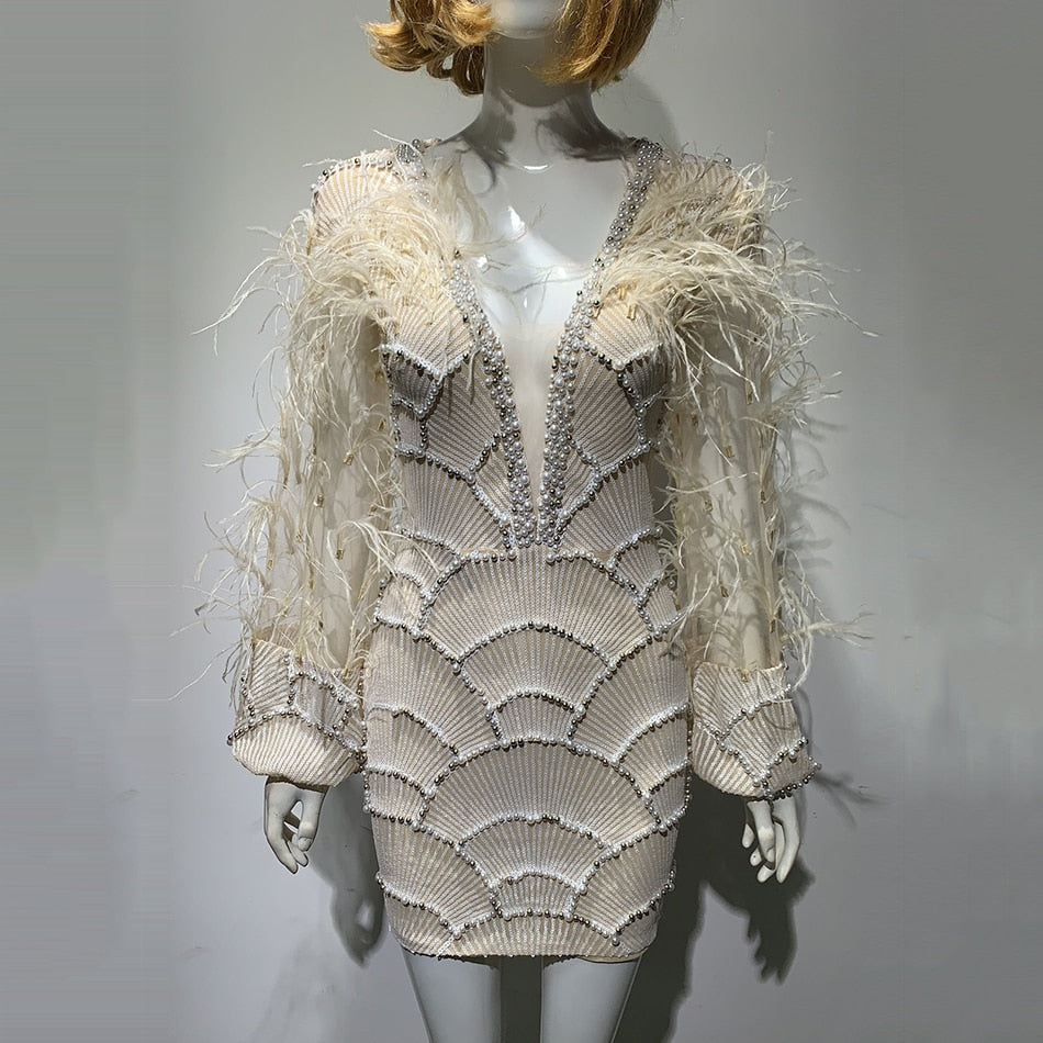 Embroidered evening dress, with feathers.